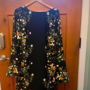 Gorgeous, black with floral dress designed to flatter curves